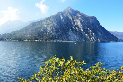 Scenic view of lake by mountains against sky