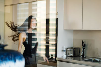 Portrait of a beautiful young woman in the kitchen