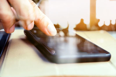 Midsection of person playing guitar on table