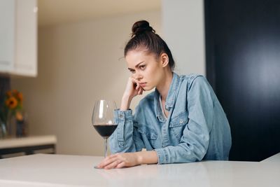 Young woman using mobile phone at home