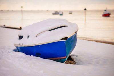 Close-up of boat moored on beach