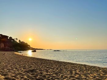 Scenic view of sea against clear sky during sunset