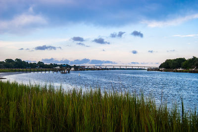 Scenic view of lake against cloudy sky