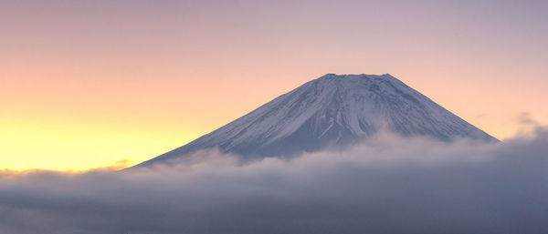 Scenic view of mountains against sky at sunset