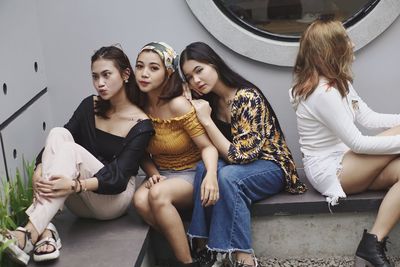 Young women sitting in traditional clothing