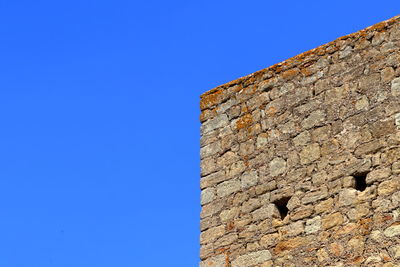 Low angle view of built structure against blue sky