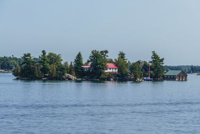 Scenic view of lake by trees against sky