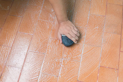 High angle view of woman hand on floor at home