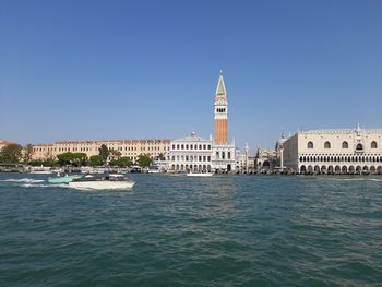 View of buildings in city against clear sky