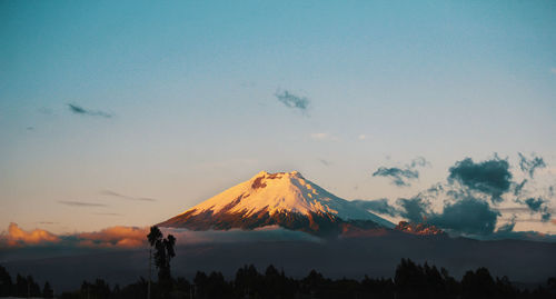 Scenic view of snowcapped mountains against sky during sunset