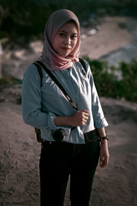 Portrait of young woman standing outdoors