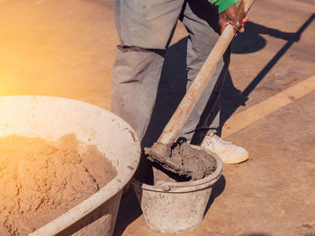 Low section of worker working at construction site