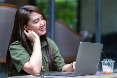 Young woman using laptop at office