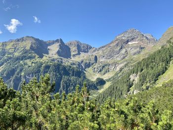 Scenic view of mountains against clear blue sky