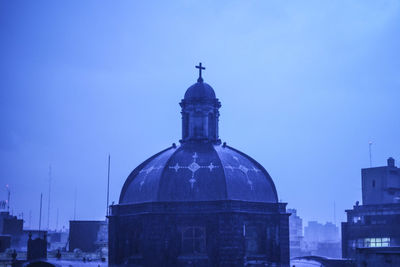 View of cathedral in city against clear sky