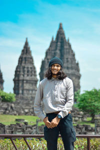 Portrait of man standing against temple