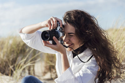 Woman photographing with camera