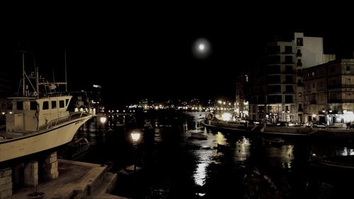 Boats in harbor at night