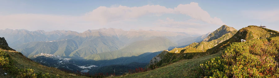 Panoramic view of mountains against cloudy sky