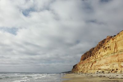 Mid distance shot of people on calm beach