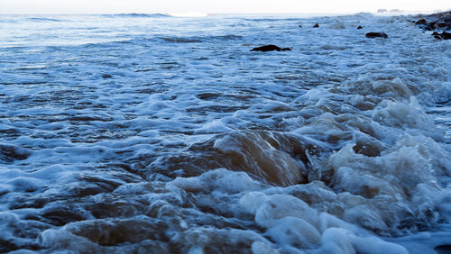 Frozen river against sky