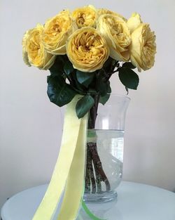 Close-up of yellow roses in vase on table