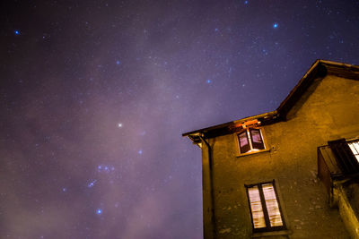 Low angle view of illuminated building against sky