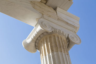 Low angle view of cross against blue sky