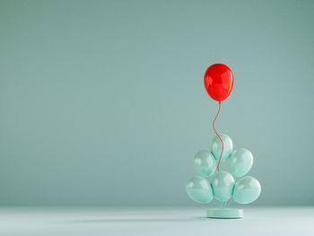 Close-up of balloons on table against blue background