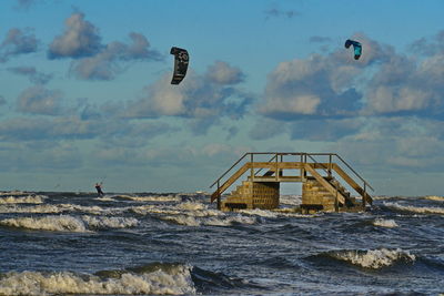 Lifeguard hut on beach against sky