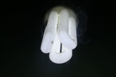 Close-up of light bulb against black background