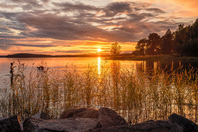 Scenic view of lake against orange sky