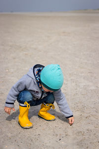 Boy playing with toy on sand