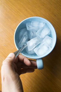 Close-up of hand holding ice cream