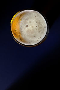 Directly above shot of coffee cup against black background