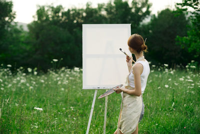 Full length of woman standing on field