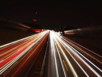 High angle view of light trails on highway at night