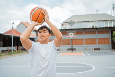 Man playing with ball on basketball court