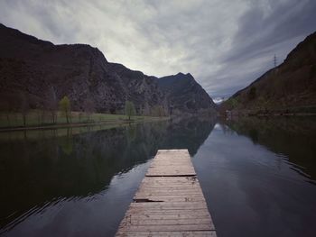 Pier over lake against sky