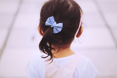 Rear view of girl standing on footpath