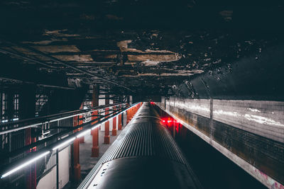 Train at illuminated railroad station