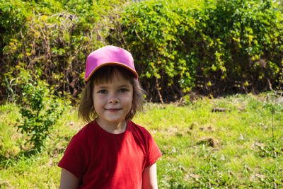 Portrait of boy standing on field