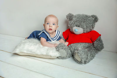 Portrait of cute baby boy lying on bed at home