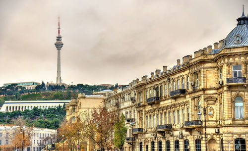 Low angle view of buildings in city against sky