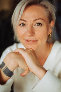 Headshot of a blond woman with short hair looking at camera