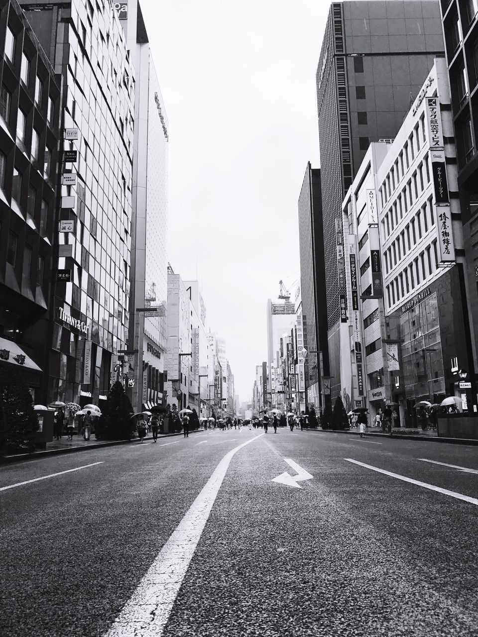 architecture, building exterior, built structure, transportation, street, city, road, surface level, clear sky, the way forward, city street, diminishing perspective, day, outdoors, tall - high, long, city life, tall