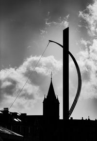 Low angle view of silhouette buildings against sky