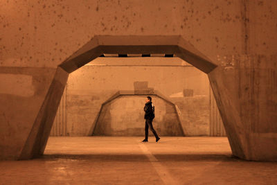 Rear view of man standing in corridor