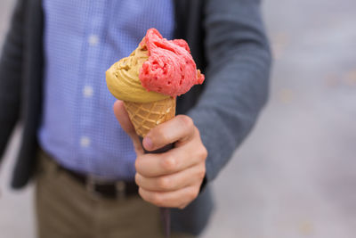 Cropped image of person holding ice cream