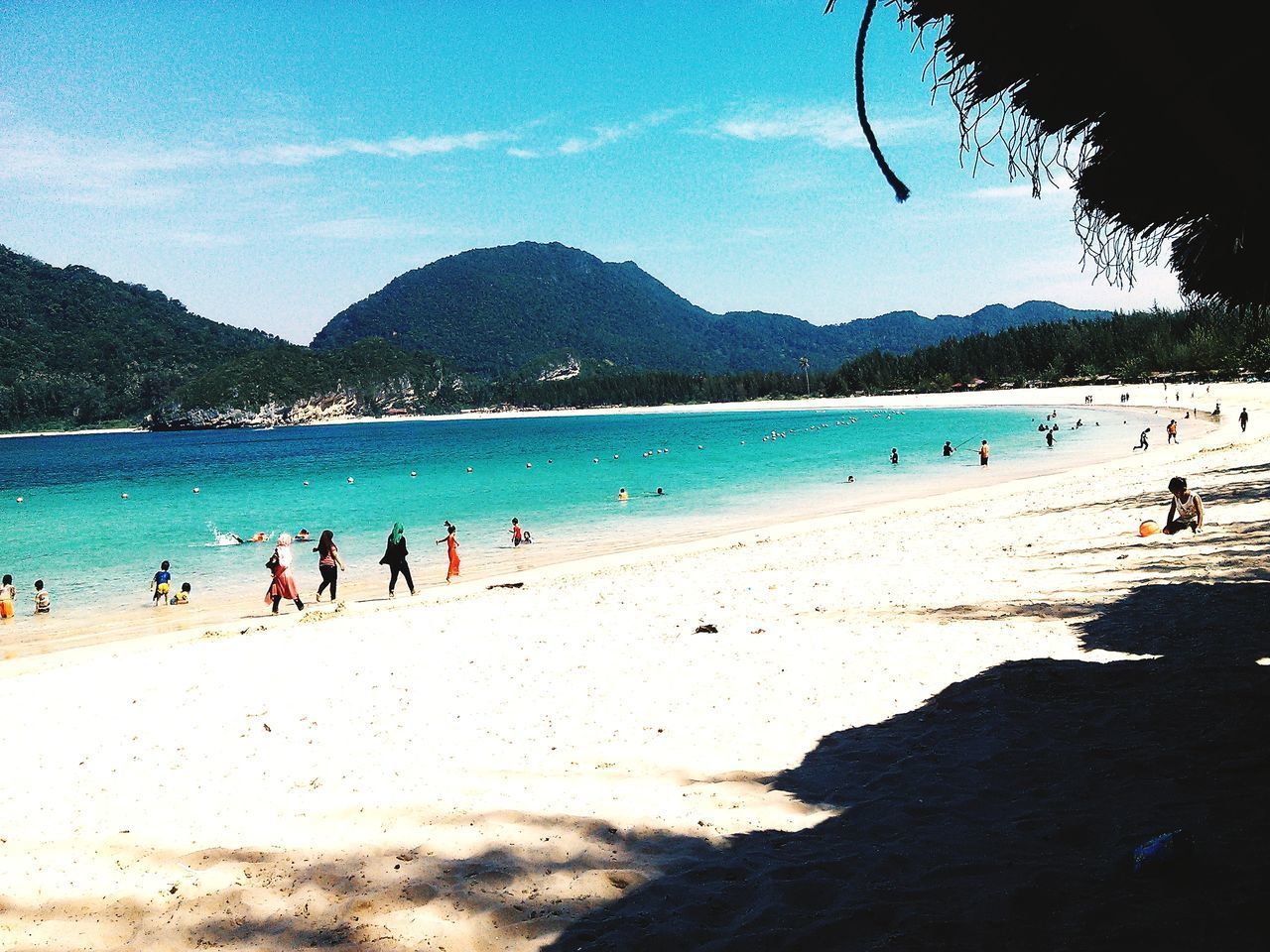 PEOPLE ON BEACH AGAINST SKY